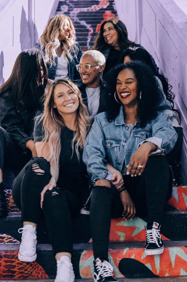 A group of friends laughing together on painted stairs